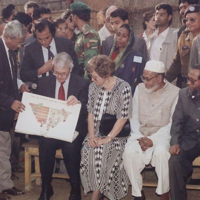 BRAC Founder Sir Fazle Hasan Abed showing awareness-raising tools to former UK Prime Minister John Major and his wife Norma Major at a village gathering in Bangladesh.