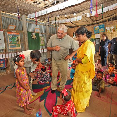 Aboriginal Australian public servant, Mick Gooda, interacting with young pupils at a BRAC school.