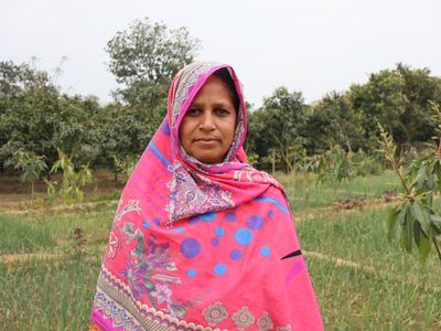 Marjina stands proud among her green crops