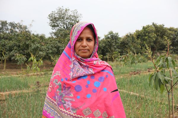 Marjina stands proud among her green crops