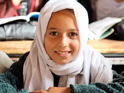 Smiling girl in a classroom at Jabul Sheraj’s government primary school