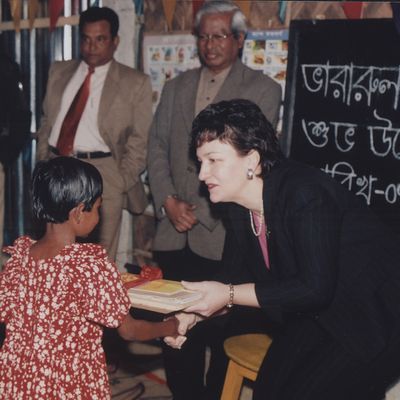 House of the Commons of Canada Member, Marie Claude Bibeau shaking hands with a young student and handing her books at a BRAC School in Dhaka, the capital of Bangladesh, on 7 January 2003.