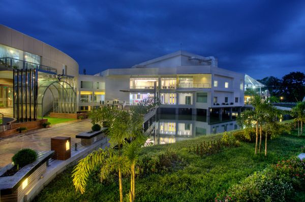 BRAC Services' Rajendrapur is illuminated at night, reflecting off the water below