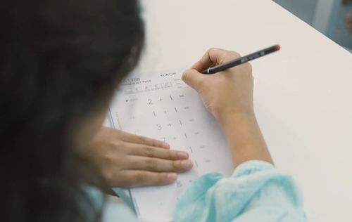 A BRAC Kumon student works on her multiplication