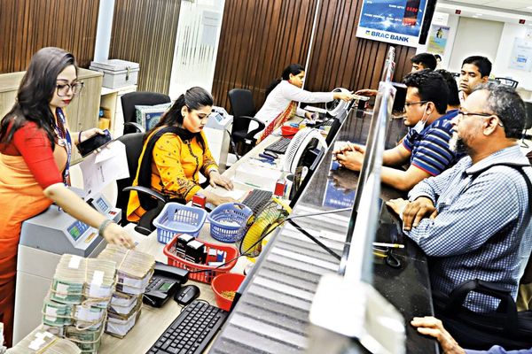 Tellers help clients who stand at the counter