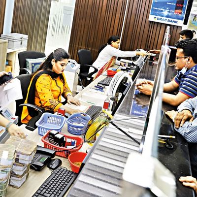 Tellers help clients who stand at the counter