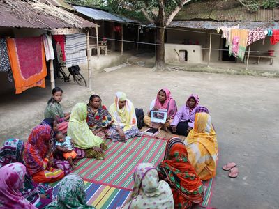 A community health worker with young mothers in Bangladesh