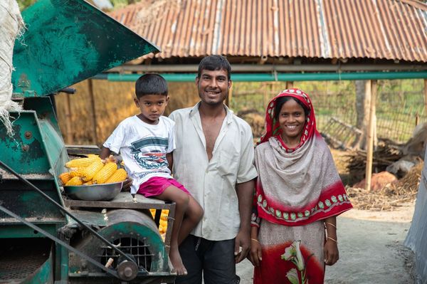 A family in the southern Bangladesh district of Rangpur stop to pose near farming machinery as part of their participation in BRAC's Ultra-Poor Graduation program (BRAC 2021)