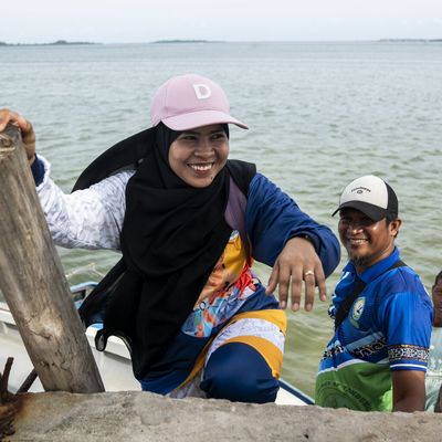 Darwina S. Tusay, AKAP Learning Facilitator for Grade 1, climbs the stairs after riding a speedboat in Tawi-Tawi, Bangsamoro Autonomous Region in Muslim Mindanao (BARMM), Philippines, on October 22, 2024. Photo by Lisa Marie David