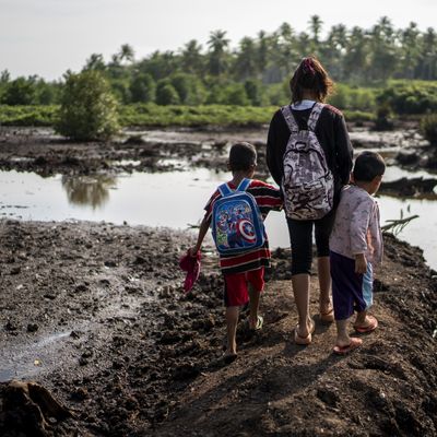 Sitti crosses a forest and a river just to get to school. - Header Image