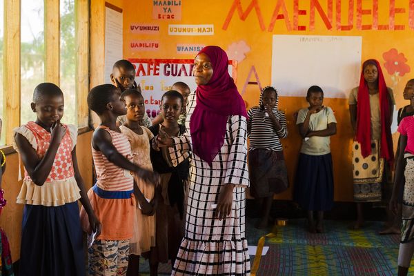 AIM Tanzania mentor and girls in BRAC youth empowerment club