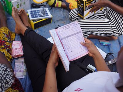 MF client group sits and reviews a cash receipt