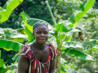 Woman farmer and MF client in Liberia working in field
