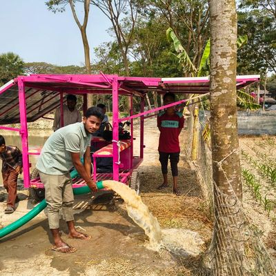 solar powered mobile cart pictured in use with man and children