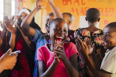 A young girl from AIM dancing and clapping