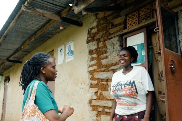 Faridah, medical caregiver in Uganda, speaks to a member of the community