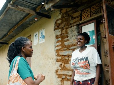 Faridah, medical caregiver in Uganda, speaks to a member of the community