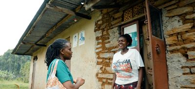 Faridah, medical caregiver in Uganda, speaks to a member of the community