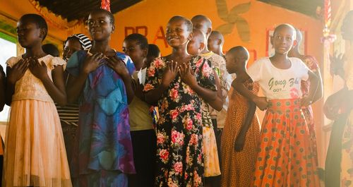 Group of girls standing together in colourful clothes