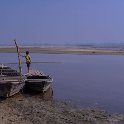 A child looks on to the horizon of a river in Rangpur Bangladesh