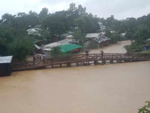 Flood waters surround a pedestrian bridge in Cox's Bazar in July 2026