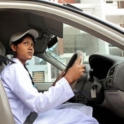 BRAC Bangladesh | Road Safety, a young woman dressed in a white coat and hat at the steering wheel