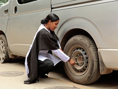 BRAC Bangladesh | Road safety, a young woman changing a tire