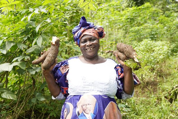 A woman holding two chickens