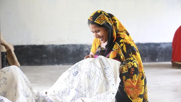 Woman stitching kantha