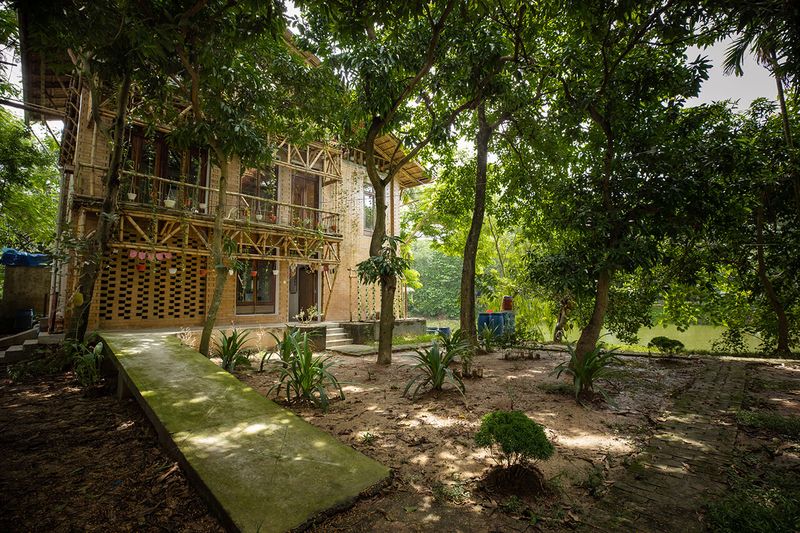 The amphibious house with its front yard that has an aquaponics setup and a ramp for persons with disabilities to access the entrance. © Shamim Hossain, BRAC 2025