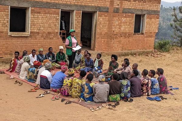 Nyamagabe Gira Wigire participants during a savings group session led by Para-Social worker, Agnes Nyirahabimana, in Kinga Village, Ngoma Cell, Cyanika Sector