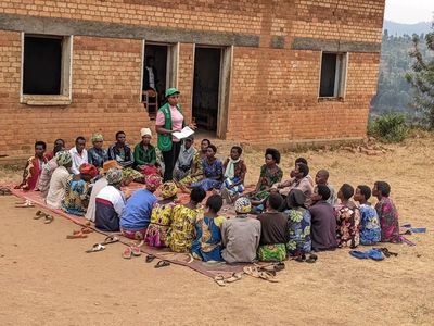 Nyamagabe Gira Wigire participants during a savings group session led by Para-Social worker, Agnes Nyirahabimana, in Kinga Village, Ngoma Cell, Cyanika Sector