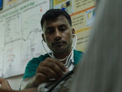 A paramedic checking the blood pressure of his patient in a community clinic in northern Bangladesh.