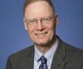 Stephen Charles Smith's headshow shows a white man with light colored hear wearing glasses. He smiles at the camera.