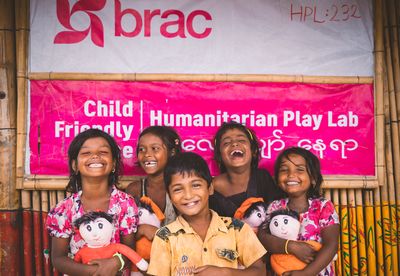 Rohingya refugee children standing in front of a humanitarian play lab in the camps in Cox's Bazar, Bangladesh