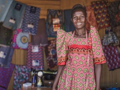 A woman standing in front of her fabrics