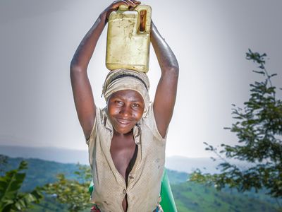 Ugandan woman standing in front of her field
