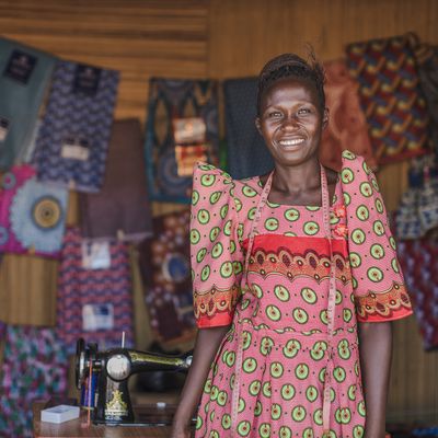 A woman standing in front of her fabrics