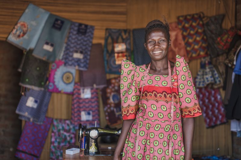 A woman standing in front of her fabrics