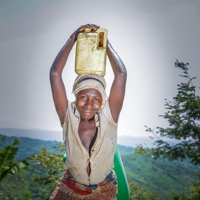 Ugandan woman standing in front of her field
