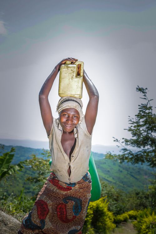 Ugandan woman standing in front of her field