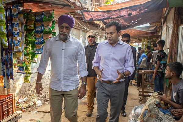 BRAC Executive Dictor Asif Saleh walking down the street of Karail, Bangladesh's biggest informal settlement, with former Minister of International Development of Canada Harjit S. Sajjan in 2023
